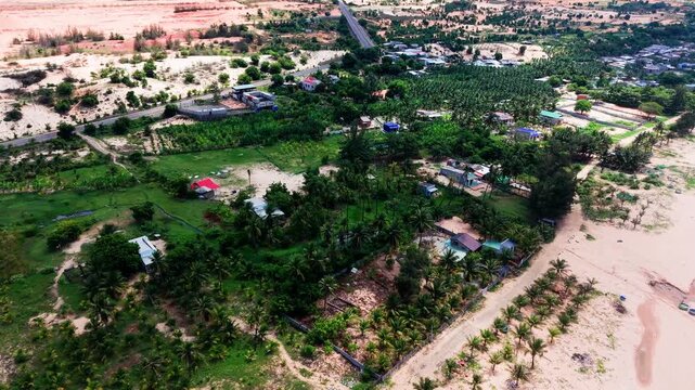 The beautiful landscapes of Hoa Thang in Lam Dong. Aerial shots present the sandy areas, green trees, and local homes. Witness the change of light during the day.