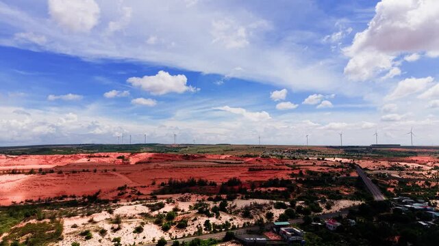The area of Hoa Thang in Lam Dong shows vast red soil and an open sky. Nature surrounds the landscape under bright clouds.