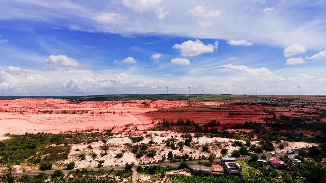 Hoa Thang in Lam Dong shows land with vibrant colours under a blue sky. The view includes hills and fields. This place has unique sights at different times of day.