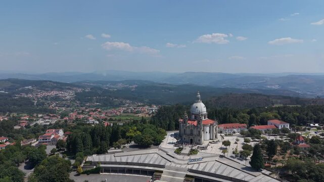 Aerial - Sameiro Sanctuary rising above pine forest and the city of Braga in North Portugal