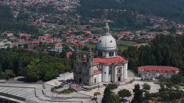 Aerial - Sameiro Sanctuary in Braga with its white dome red roofs and visitors on the square