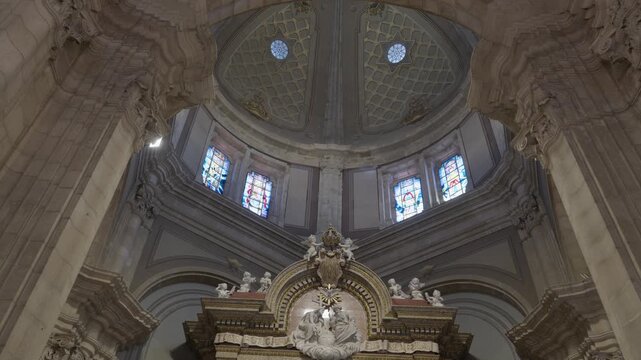 Stone dome of Sameiro Sanctuary in Braga with stained glass windows above a gilded altar