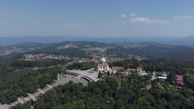 Aerial - Sameiro Sanctuary above pine forest and esplanade with Braga and the hills beyond