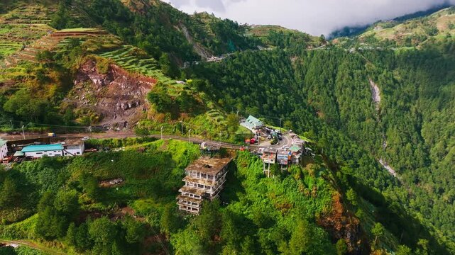 Drone turns left above Halsema Highroad Point as clouds drift across green peaks