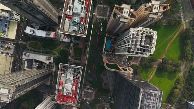 Top down drone flies forward then turns right above Bonifacio Global City towers