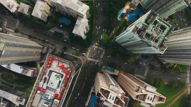Top down aerial view captures moving traffic among BGC towers in Metro Manila