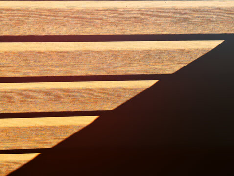 Diagonal light ray on horizontal wooden panels background