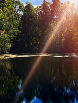 Dramatic light beam falling on the lake surface background