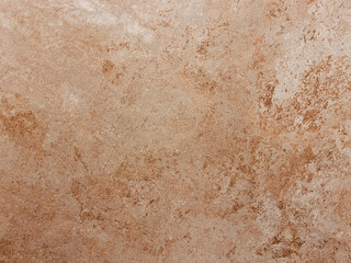 Fototapeta premium Close up of a textured brown stone surface with natural patterns and earthy tones, suitable for backgrounds or design elements.