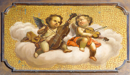 Naklejka premium VERCELLI, ITALY - JANUARY 17, 2026: The painting of angels with the music instruments in the church Chiesa di Sant' Agnese in San Francesco by unknown artist