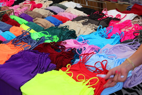 Colorful womens tank tops and camisoles displayed on a market stall table in Treporti Italy