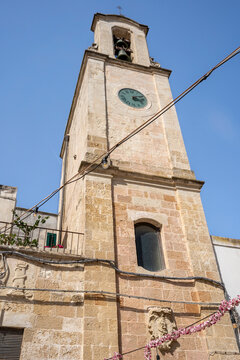 Clock tower in the historic center of Otranto, surrounded by traditional buildings and a relaxed atmosphere reflecting the slow pace of life, Otranto, Salento, Puglia, Italy.