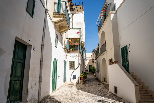 Picturesque street in the historic center of Otranto, with traditional buildings and a relaxed atmosphere reflecting the slow pace of life, Otranto, Salento, Puglia, Italy.