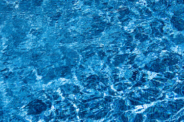 Clear Blue Water Surface Showing Bright Sunlit Ripples And Dynamic Patterns © Wendy