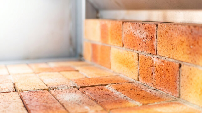 Metal furnace interior with brick wall in warm tones  