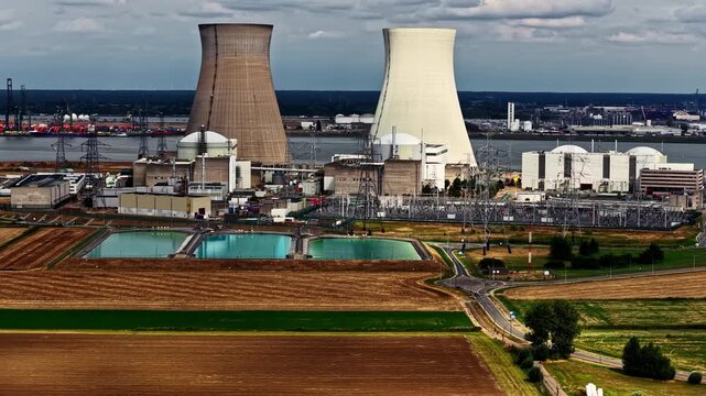 Aerial view of the Doel Nuclear Power Plant with its cooling towers and reactor buildings situated near the Scheldt river in Beveren-Kruibeke-Zwijndrecht, Vlaanderen, Belgium.