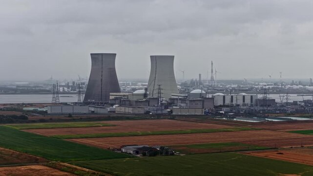 Aerial view of the Doel Nuclear Power Plant with its cooling towers and industrial facilities situated near the Scheldt river, Beveren-Kruibeke-Zwijndrecht, Vlaanderen, Belgium.