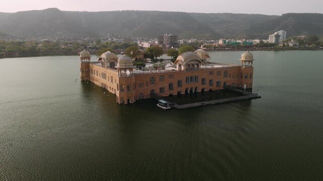 Aerial view of jal mahal water palace on man sagar lake in jaipur, rajasthan, india, with a boat sailing