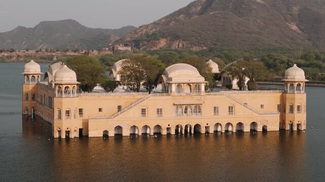 Aerial view of jal mahal palace in jaipur on man sagar lake in rajasthan, india, during sunset