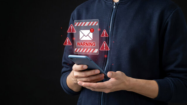 Individual using a mobile phone with floating warning signs and malicious email alerts.