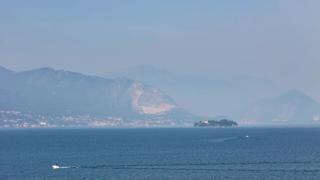 Aerial 4K drone video footage with panorama of Lake Maggiore, Italy, with majestic Alpine mountains surrounding the scenic lake, showcasing the breathtaking landscape of the Italian Lakes region