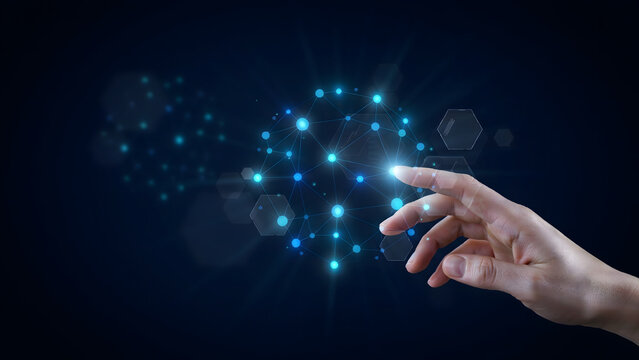 Human hand touching a glowing blue digital network node connection point on a dark background, representing artificial intelligence technology