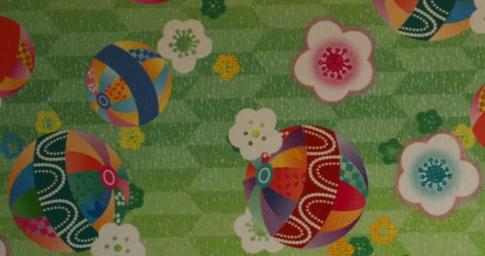 Traditional Japanese Floral and Temari Pattern on Green Background - Colorful traditional Japanese-inspired pattern featuring decorative temari balls and delicate plum blossoms on a textured green bac