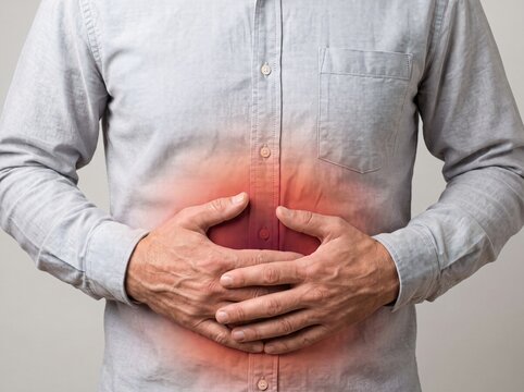 Man holding stomach with painful abdominal ache and digestive health issues