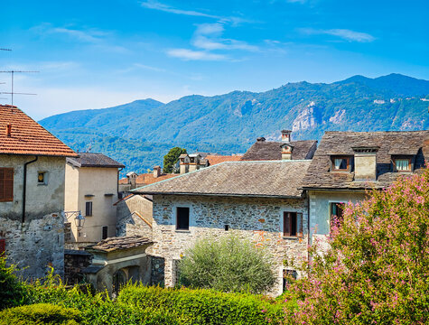 Panoramic view of Orta San Giulio on the shores of Lake Orta, Piedmont, Italy. Aerial drone view showcasing the historic lakeside town and picturesque Alpine landscape