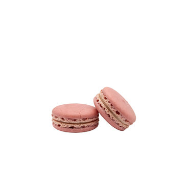 Two pink french macarons with cream filling arranged together on a plain white surface isolated on a transparent background