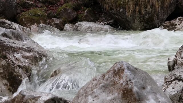 Fast flowing mountain river streaming around rocks