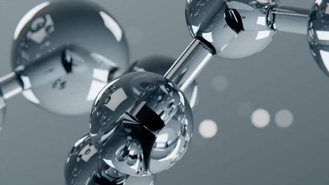Orbiting camera revealing rotating chrome spheres in studio, showing dark core, rods, bubbles