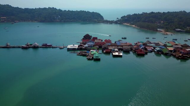 speed ramp time lapse Coastal community living in houses on stilts over calm water, surrounded by lush green islands traditional life. Beautiful aerial view speed ramp time lapse fly reverse drone