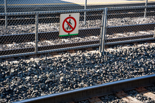 No pedestrian access sign beside railway tracks.