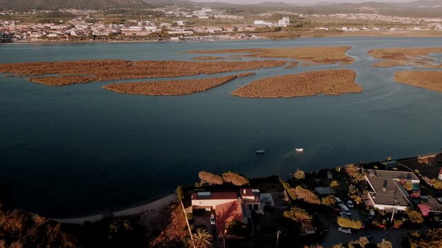 Aerial - Ofir estuary with marsh islands moored boats and Esposende across the water