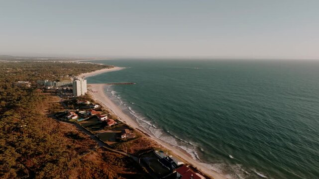 Aerial - Ofir shoreline with beachfront buildings groyne and Atlantic waves in Portugal