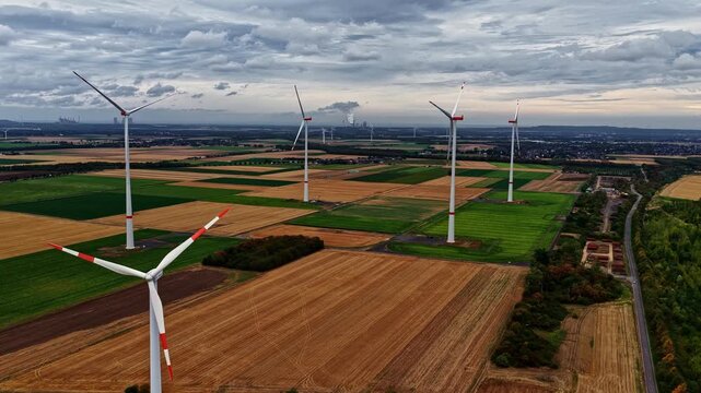 Aerial view of wind turbines standing in agricultural fields near the Tagebau Hambach open-pit mine in Elsdorf, Nordrhein-Westfalen, Germany.