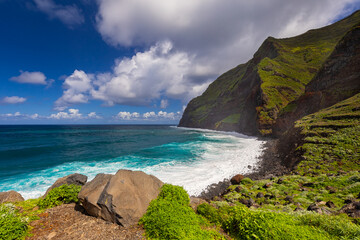 Coastal landscape with cliffs, beach and ocean under blue sky with clouds, Achadas da Cruz, Madeira © anettastar