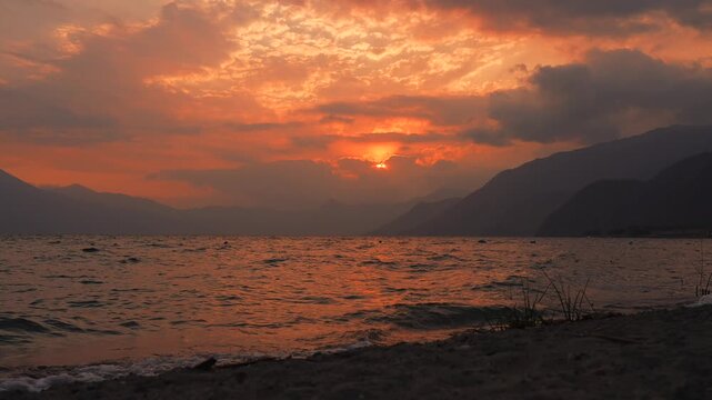View of sun setting behind clouds in Panajachel, Lake Atitlan, Guatemala