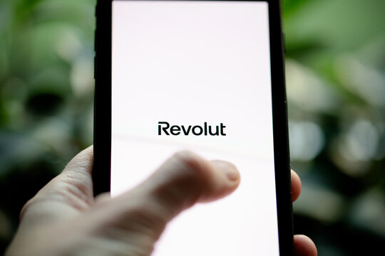 CCLUJ-NAPOCA, ROMANIA - 24th FEBRUARY, 2025: A person is opening Revolut app on a phone