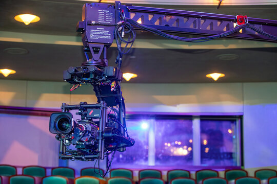 Professional broadcast camera on a robotic crane jib in a studio setup