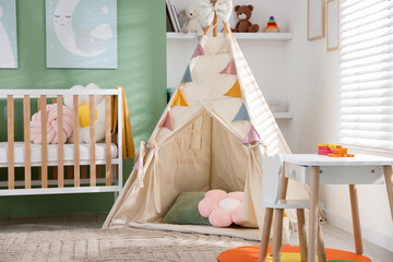 Cute baby room with comfortable crib, wigwam and other toys. Interior design © New Africa