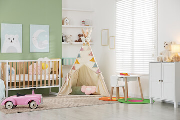 Spacious baby room with different furniture and toys. Interior design © New Africa