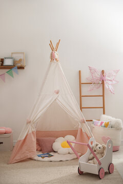 Wigwam and other toys in baby's room. Interior design
