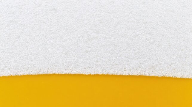 Extreme close up of orange liquid with white foam bubbles on top for beverage background.