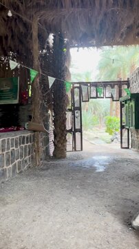 Historic stone well and rustic millstones in a traditional Arabic village oasis.