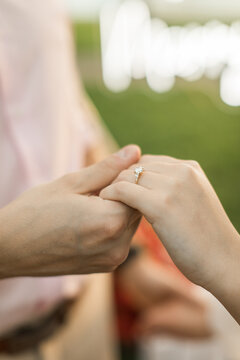 Man and woman holding hands after a marriage proposal for their engagement