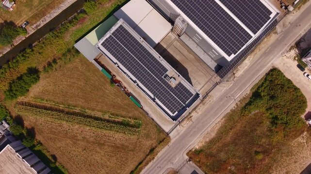 Aerial Top Down View of Modern Factory Rooftops Covered with Solar Panels in Industrial Zone Near Vogosca Bosnia and Herzegovina