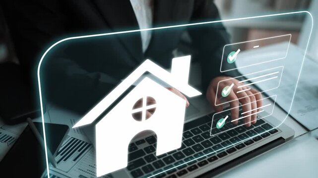 Hand of a Businessperson Using Laptop with Home Symbol to Represent Real Estate Management and Online Property Transactions in a Modern Office Environment Gluon.
