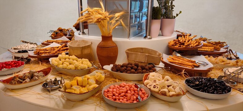 Luxurious hotel dessert buffet display with assorted sweets, chocolates, pastries and breadsticks